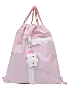 Lightweight pink drawstring backpack with bear charm and front zipper pocket for casual use