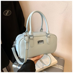 Close-up of mint blue Boston bag showing lychee grain leather and silver hardware