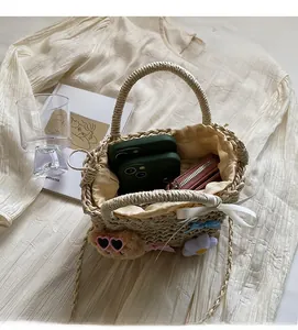 Top view of woven straw bucket bag interior with plush bear and daily essentials inside