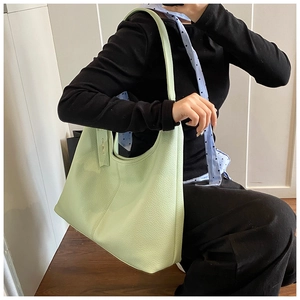 Detail of the soft lychee grain leather texture on this light green hobo shoulder bag