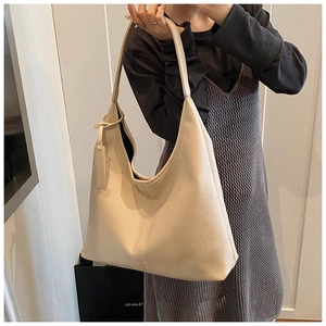 Close-up of beige lychee grain leather hobo shoulder bag with textured finish