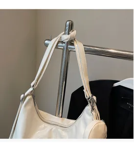 Detail of cream white leather half-moon bag with matching small round coin purse