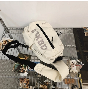 Close-up of a white waterproof sling bag with BTXBD logo on a metal grid display