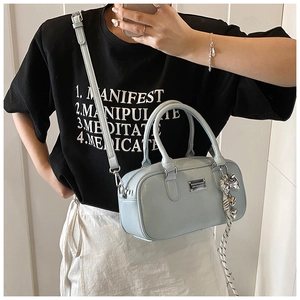 Mirror selfie showing a light blue Boston bag with silver plate and tassel detail