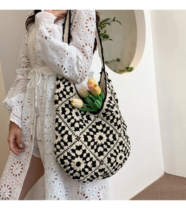 Detail of hand-crocheted tote bag featuring black and white geometric floral patterns