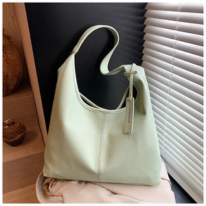 Detail of mint green pebble grain leather tote bag with elegant vertical stitching