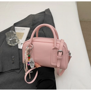 Pink lychee grain Boston bag with stylish beaded charms and silver hardware detail