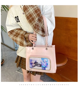 Pink glossy tote bag featuring a transparent display window for anime cards and badges
