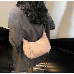 Detail of pink half-moon shoulder bag with marble texture and metallic bead tassel