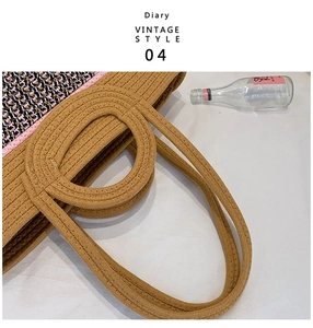 Close-up of durable woven handles and textured pattern on a large straw tote beach bag