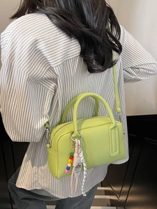 Chic light green lychee pattern pillow bag with a stylish colorful beaded charm pendant