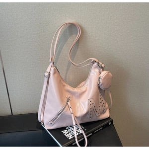 Detail of light pink hobo bag with stud M-logo, mini round pouch and shiny leather finish