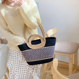 Detail of multi-color woven tote bag with round handles and cotton rope texture