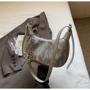 Detail of silver metallic hobo bag featuring crinkled texture and chunky metal chain strap
