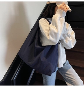 Close-up of deep blue oversized canvas tote bag showing large capacity and soft texture