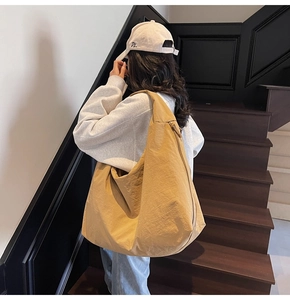 Detailed side view of khaki canvas tote bag showing the texture and large capacity