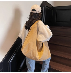 Detail view of khaki nylon crescent bag showing large capacity and soft slouchy texture