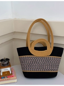 Large woven beach shoulder bag with pink, black, and white patterns and dual handles