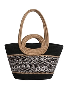 Black woven straw tote bag with geometric pattern and round brown handles for beach vacation