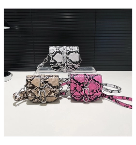 Detailed view of three mini crossbody bags featuring textured faux snakeskin in various colors