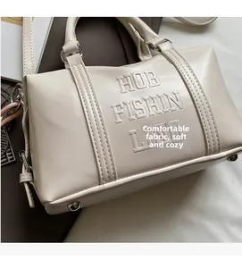 Detail of Boston bag with letter embossing, abacus pendant and textured PU leather
