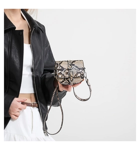 Detail showing the exotic snake pattern texture and metal buckle on this mini saddle bag