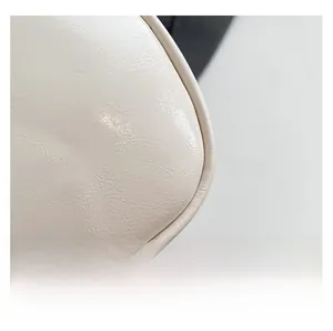 Close-up of premium PU leather texture and neat stitching on beige crossbody bag