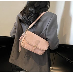 Model wearing a pink marble texture shoulder bag with decorative scarf and gold buckle