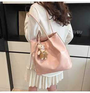 Pink tote bag detail with cute bear charm and magnetic closure for daily casual use