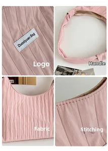 Detail view of pink pleated tote bag fabric with Duociyuan Bag label and stitching