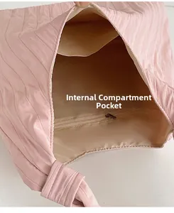 Detail view of pink pleated tote bag interior with zipper pocket and compartments