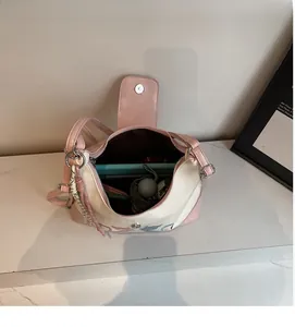Detailed interior of the pink and cream shoulder bag showing large storage capacity