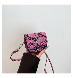 Mini crossbody bag featuring pink and black snakeskin pattern with silver metal buckle detail