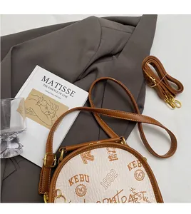 Detail of adjustable brown shoulder strap and pebbled leather bag texture