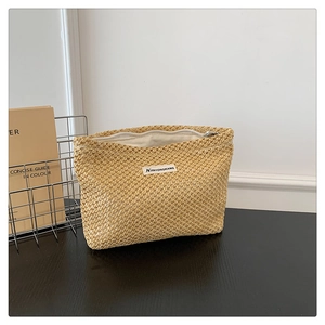Detailed view of woven texture and metal zipper closure on the beige small makeup pouch