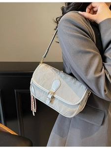 Chic silver crossbody underarm bag with pleated texture and stylish knot ornament