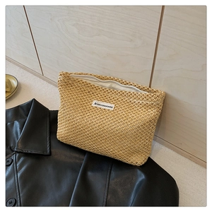 Detail of hand-woven canvas makeup bag with white zipper on black leather background