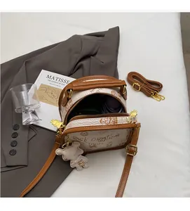 Internal view of cream leather crossbody bag showing space for phone and umbrella