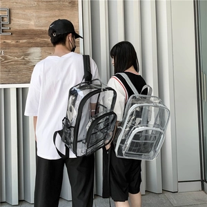 Detail view of transparent PVC backpack with black and white trim and side mesh pockets