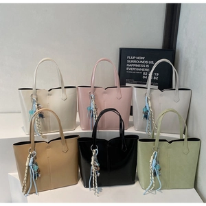 Multi-color minimalist tote bags display featuring V-cut tops and stylish charm pendants