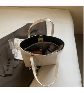 Top view of spacious cream tote bag interior showing capacity for phone and wallet