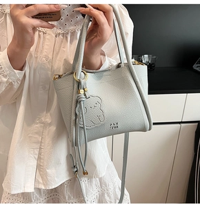 Close-up of light blue lychee pattern leather bucket bag with PANTOR brand logo