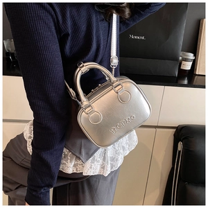 Detailed shot of silver bowling bag with RETRO embossing and adjustable strap