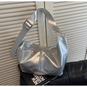 Detail of silver metallic hobo bag with wide shoulder strap and square buckle buckle