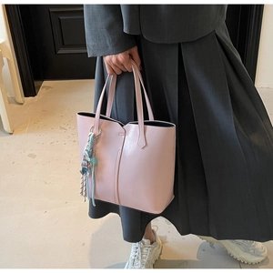 Detail of light pink tote bag with matte leather finish and decorative floral silk scarf