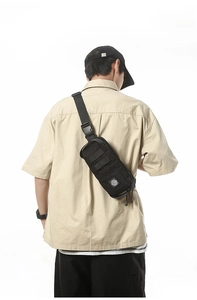 Tactical black crossbody chest bag with MOLLE webbing and adjustable strap back view