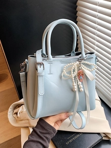 Ice blue bucket handbag with pearl bow and cartoon charm for women in 2026 fashion