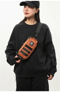Caramel outdoor chest bag with black MOLLE webbing and brand patch on nylon fabric