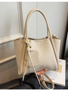 Creamy white litchi leather bucket bag with 3D bear embossment and golden hardware