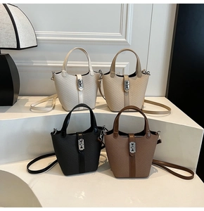 Detail view of stylish woven bucket bags in four colors with elegant metal clasp